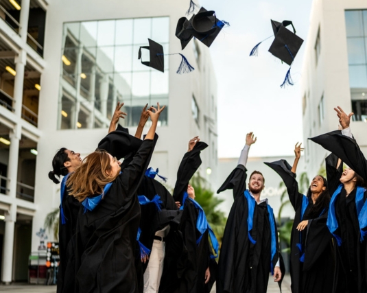 College students throwing their caps in the air