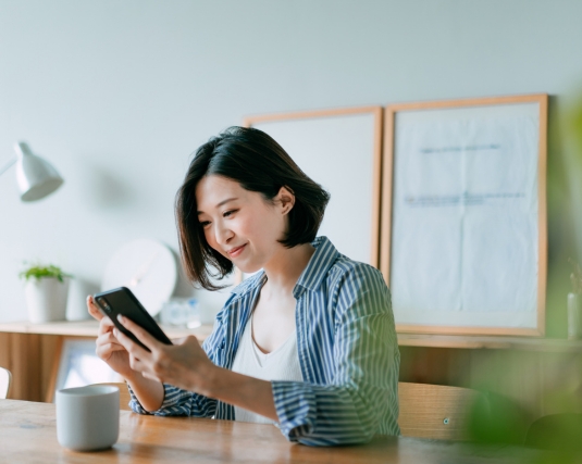Woman checking her phone and smiling