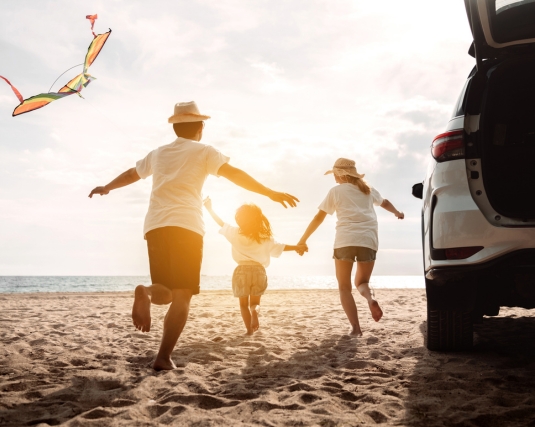 Happy Family on beach with car travel road trip.