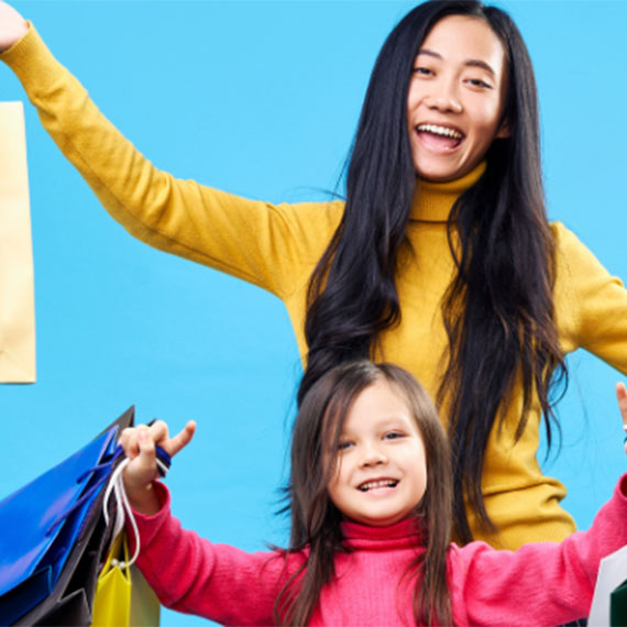 Mother and daughter holding shopping bags