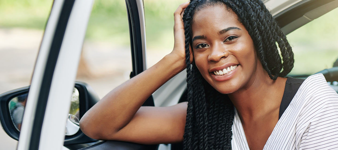 Young woman sitting in her car