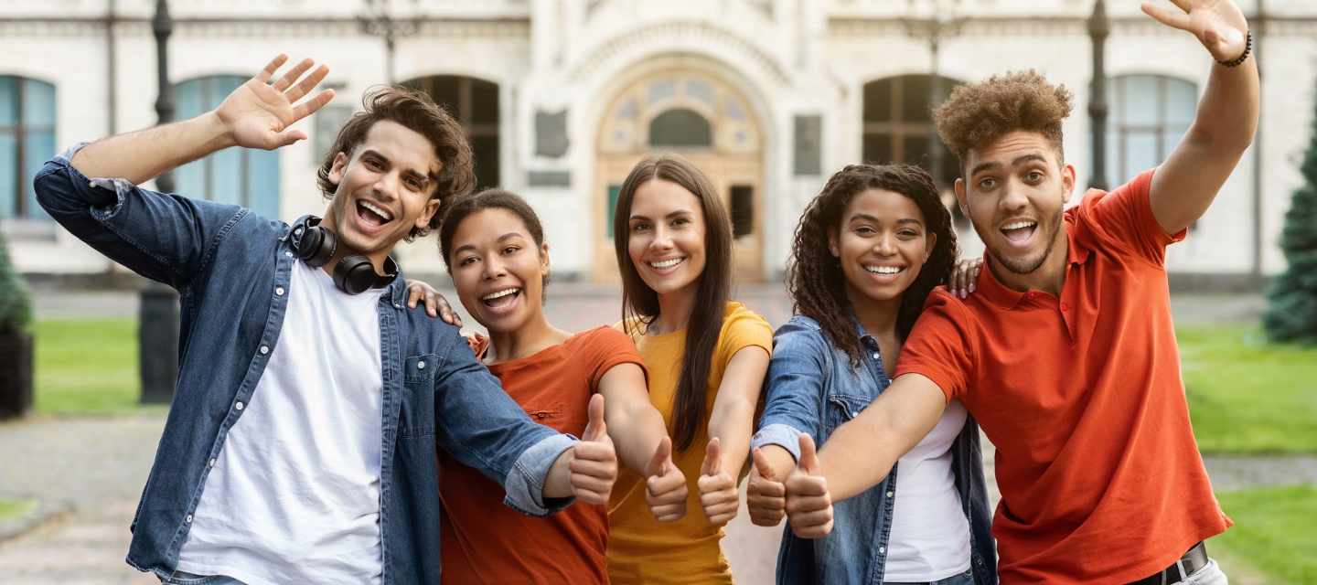 Group of diverse friends with their thumbs up for approval.