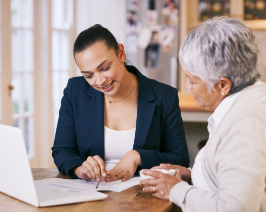 A daughter helping her mother go through her finances.