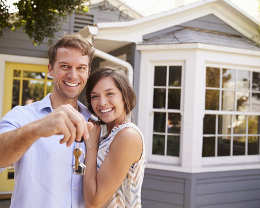 Couple holding the keys to their new home