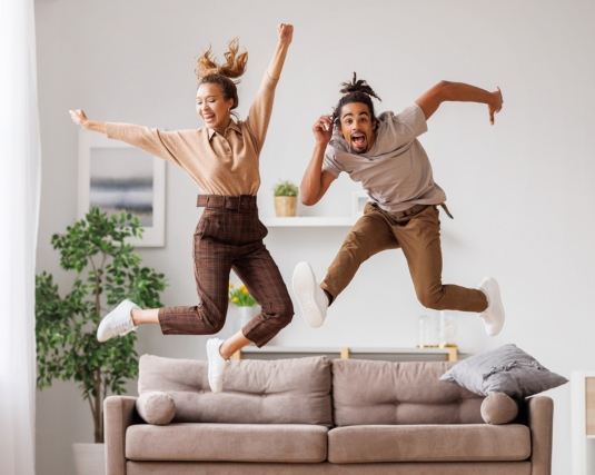 Couple jumping up and down excitedly