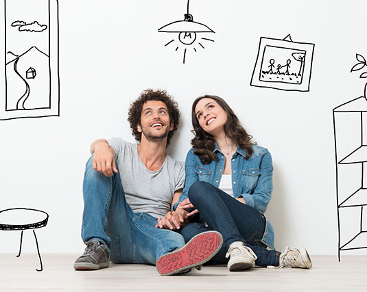 Couple sitting on the floor in a drawn room