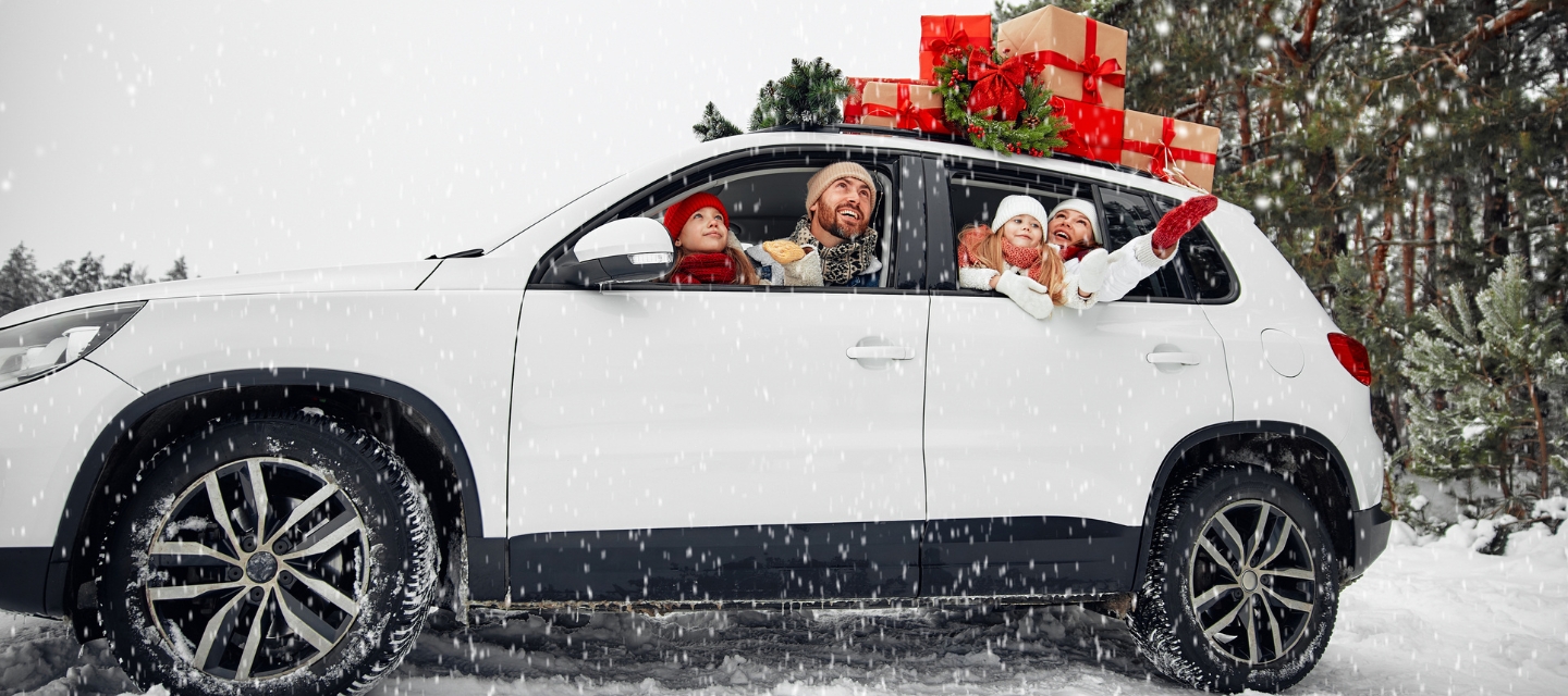 Family preparing for Christmas and New Year holidays in their car.