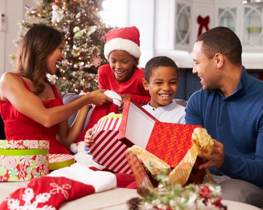 African-American family opening holiday gifts