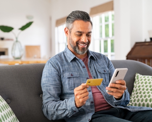 Man using his credit card to make an online purchase.