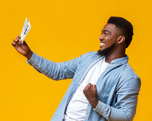 Excited man holding money