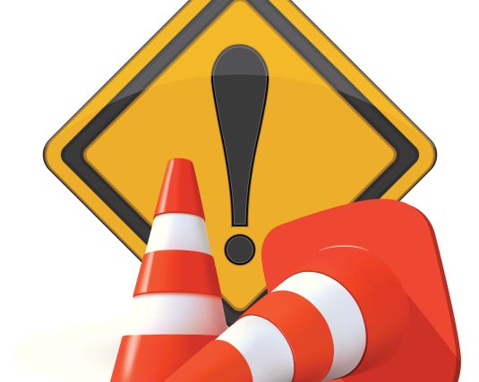 attention sign with orange and white construction cones